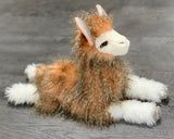 18-inch weighted llama plush with curled lashes, feathery tan fur, white legs, and sparkly hooves in a relaxed laying pose.