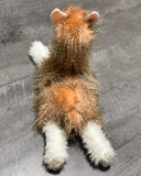 Back view of the weighted llama showing long feathery coat and floppy, soft legs.