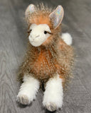 Close-up of the llama’s face with sparkly ears, long lashes, and soft feathery faux fur.