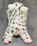 Top-down view showing curly tail and all-over spots on 17-inch weighted pig plush.