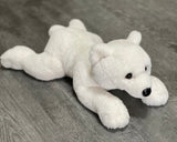Weighted polar bear plush laying flat, 22 inches long, low-profile design with plush fur.