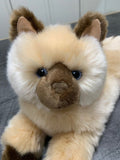 Weighted Himalayan cat plush with blue eyes and chocolate-point face, cream fur.