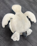 Underside of gray weighted sea turtle plush showing its cream-colored belly, four flippers, and soft construction.