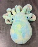 Front view of teal green blue weighted octopus with curled textured tentacles on gray wood surface