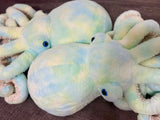 Two teal-green-blue weighted octopuses side by side to show unique fabric variation.