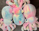 Three cotton-candy weighted octopus plush toys side by side showing varied pink, blue, yellow patterns