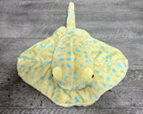 Top-down, Front view of 22-inch blue spotted weighted stingray plush showing its 18-inch wingspan, sectioned wings, and long soft tail.