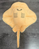Underside of blue spotted weighted stingray stuffed animal showing its soft golden belly, embroidered gill markings, wide wings, and unweighted tail.