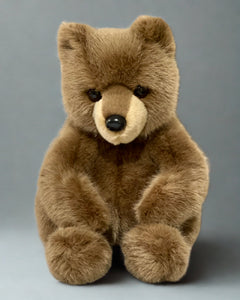Weighted brown bear plush sitting upright with realistic fur, 19 inches tall, designed for lap hugs.