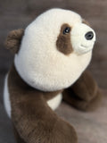 24-inch adjustable weighted panda plush with ultra-soft brown and cream fur, close-up side view of face.