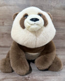 Close-up front view of sitting 24-inch adjustable weighted panda plush with realistic embroidered smile and soft faux fur.