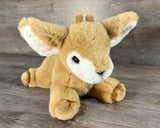 Weighted deer stuffed animal lying down with soft plush fur and realistic fawn face