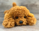 Soft weighted Cockapoo stuffed animal lying down with textured curly poodle-style fur, designed for comforting cuddles and sensory support.