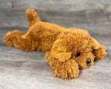 Weighted Cockapoo doodle plush resting in a relaxed laying position with curly poodle-like coat and floppy paws for soothing comfort.