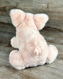 Back view of weighted pink pig plush showing curly tail and super-soft plush fur