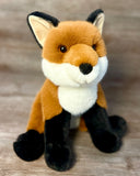 Weighted fox plush sitting with super-soft orange fur, black legs, and fluffy white chest