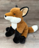 Side view of weighted fox stuffed animal with fluffy white-tipped tail and soft plush fur