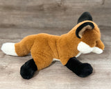 Weighted fox plush lying down showing long body, soft fur, and white-tipped tail