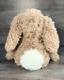Back view of weighted curly bunny plush with fluffy white tail and long floppy ears.