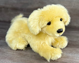 Close three-quarter view of a weighted Golden Retriever plush with realistic puppy face and luxurious faux fur.