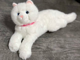 Side view of 15-inch white weighted cat toy showing soft fur and paws.