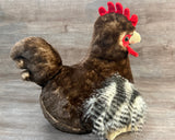 Side sitting view of weighted rooster plush with soft brown body and realistic feathered wings.