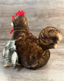 Back view of weighted rooster plush showing curled tail and feathered wings.