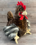 Three-quarter front view of weighted rooster plush sitting upright.