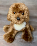Chocolate Labradoodle weighted stuffed dog sitting upright with silky plush coat