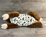 Underside of a 23-inch weighted goat plush showing the full-body laying design.