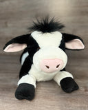 Front view of a 23-inch weighted Holstein cow plush stuffed animal with fluffy forelock.