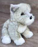 Side angle view of handmade weighted Mini Schnauzer stuffed dog with ultra-soft silver plush and fluffy beard sitting upright.
