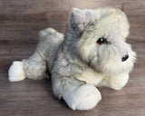 Mini Schnauzer weighted plush lying down with silky silver-gray coat and soft fluffy paws and beard.