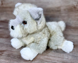 Side profile of laying weighted Mini Schnauzer stuffed animal with realistic features and premium plush fur