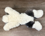 Bottom view of weighted Sheepadoodle plush showing floppy body and fluffy paws