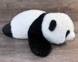20-inch weighted panda stuffed animal lying down, angled side view