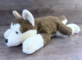 Brown and white full-body weighted Husky plush lying down, three-quarter side view