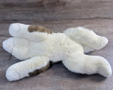 Underside of 22-inch brown and white weighted Husky stuffed animal showing full-body design