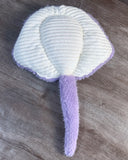 Underside of lavender weighted stingray plush showing thick, white ribbed sensory fabric, wide weighted wings, and unweighted purple tail.