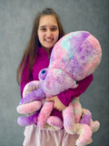 Model holding giant purple pink blue weighted octopus to show scale