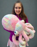 Model holding giant cotton-candy weighted octopus to show scale and size