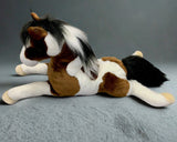 Side view of weighted 27-inch paint horse stuffed animal in brown and white, showing two-tone black and white mane and tail in a laying pose.